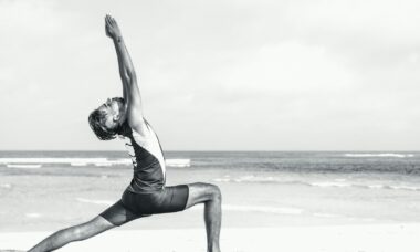 man stretching on seashore